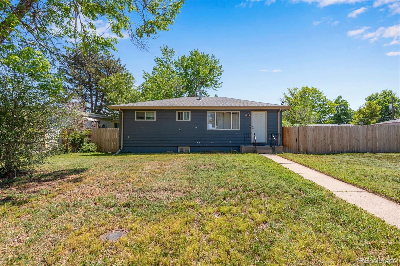 934 Linley Court Denver, CO 80204 - Photo 2 of 17 a front view of a house with a yard