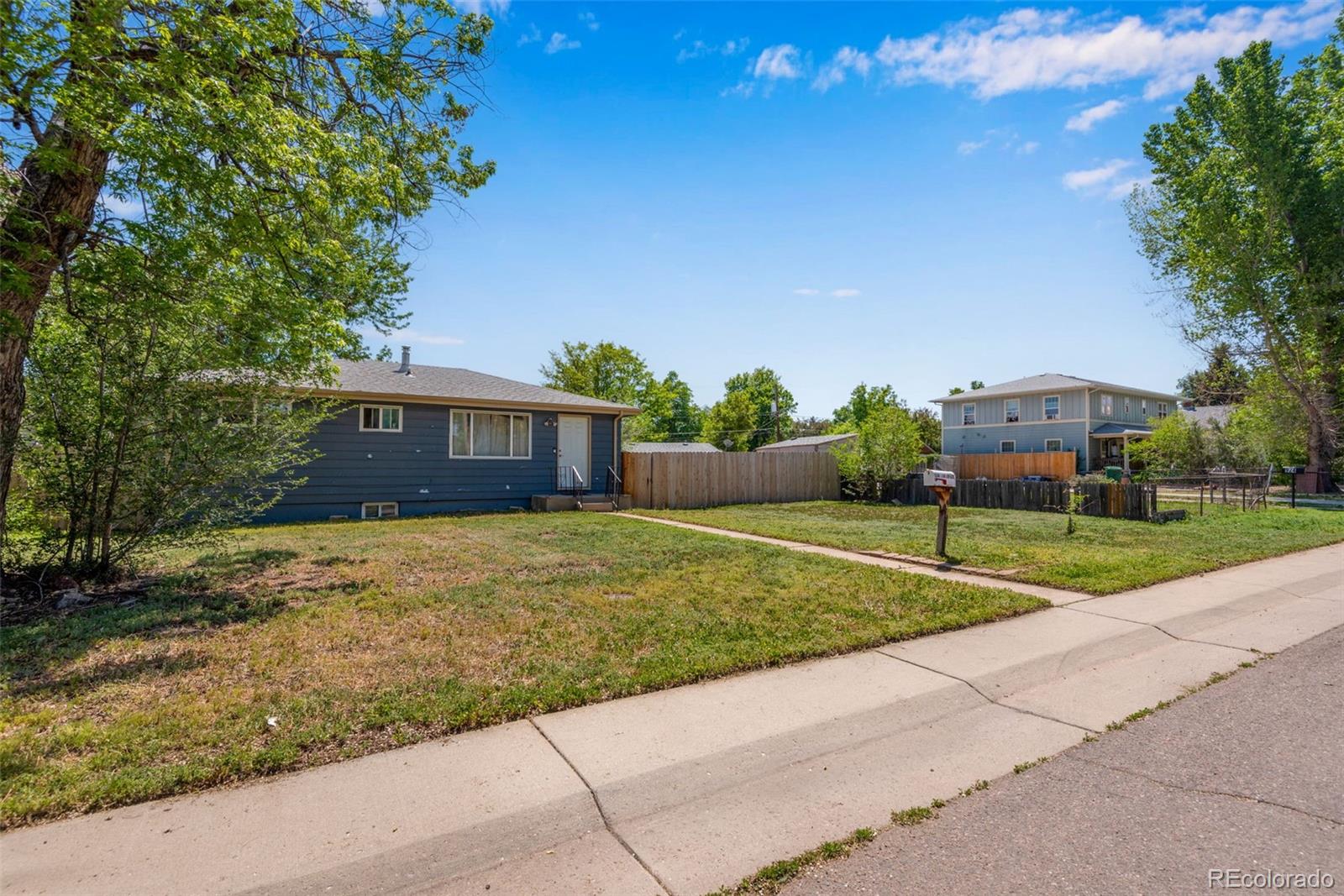 934 Linley Court Denver, CO 80204 - Photo 8 of 17 a front view of house with a yard and trees