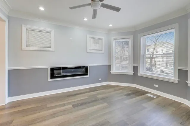 a view of a livingroom with a ceiling fan and window