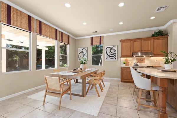 a dining room with furniture and wooden floor