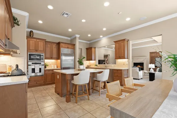 a large kitchen with a sink and refrigerator