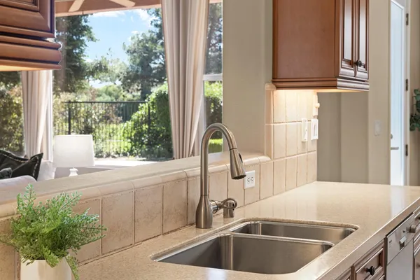 a spacious bathroom with a granite countertop tub a sink and a large window