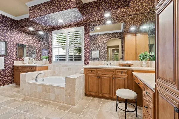 a bathroom with a double vanity sink toilet and shower