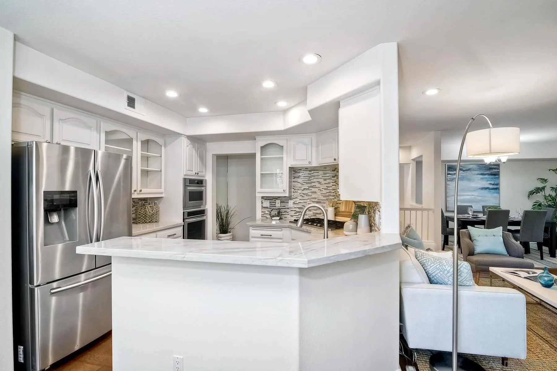 2872 Torrey Pines Road La Jolla, CA 92037 - Photo 11 of 34 a kitchen with stainless steel appliances granite countertop a sink refrigerator and cabinets