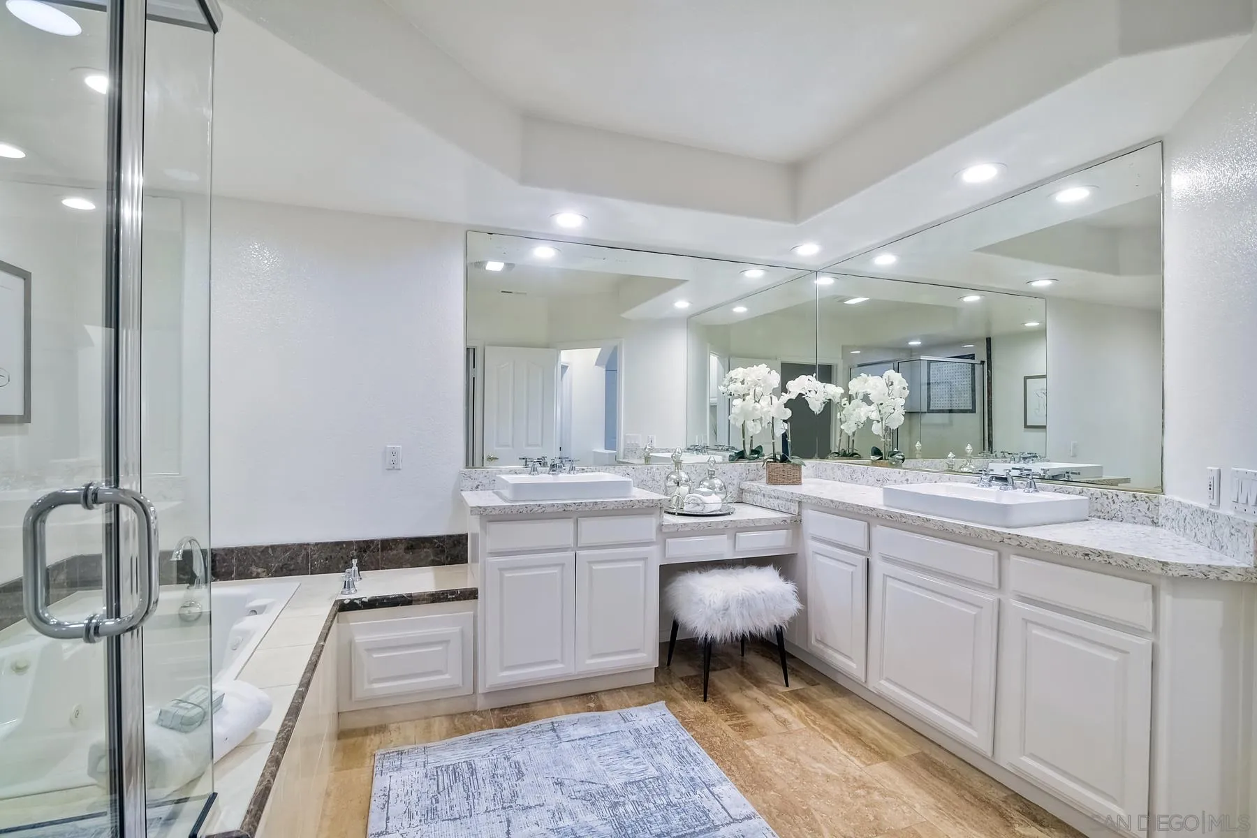 2872 Torrey Pines Road La Jolla, CA 92037 - Photo 24 of 34 a large bathroom with a large mirror vanity and shower