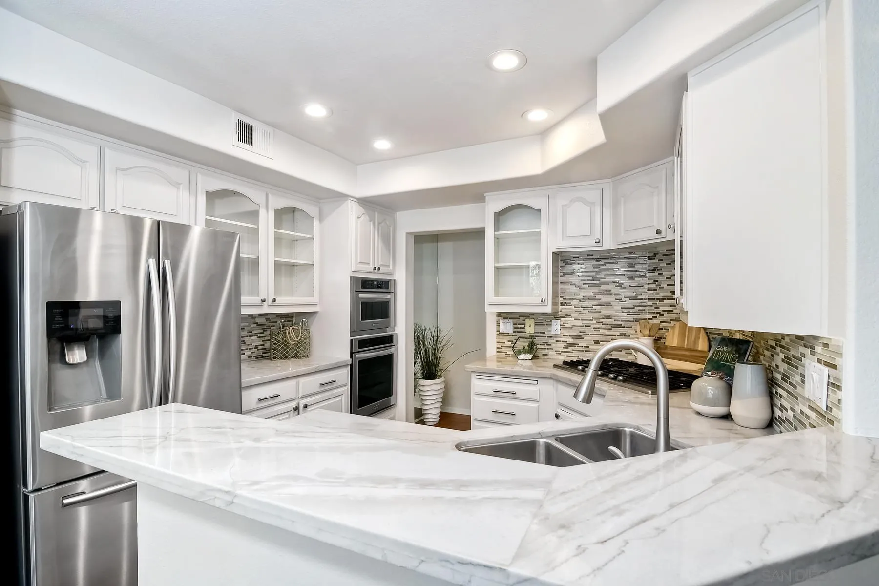 2872 Torrey Pines Road La Jolla, CA 92037 - Photo 9 of 34 a kitchen with stainless steel appliances kitchen island granite countertop a refrigerator and a sink