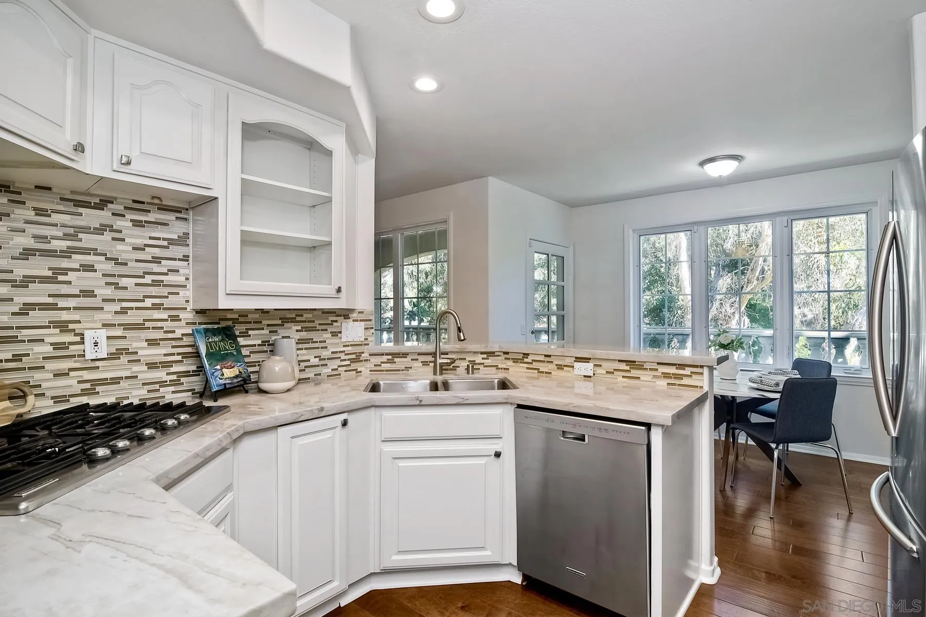 2872 Torrey Pines Road La Jolla, CA 92037 - Photo 10 of 34 a kitchen with a sink stove and wooden cabinets