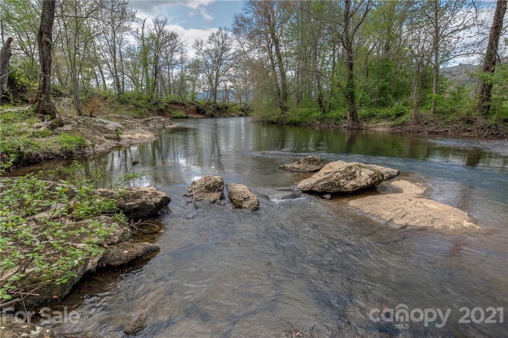 208 Wells Road Canton, NC 28716 - Photo 15 of 35 a body of water with a tree in the background
