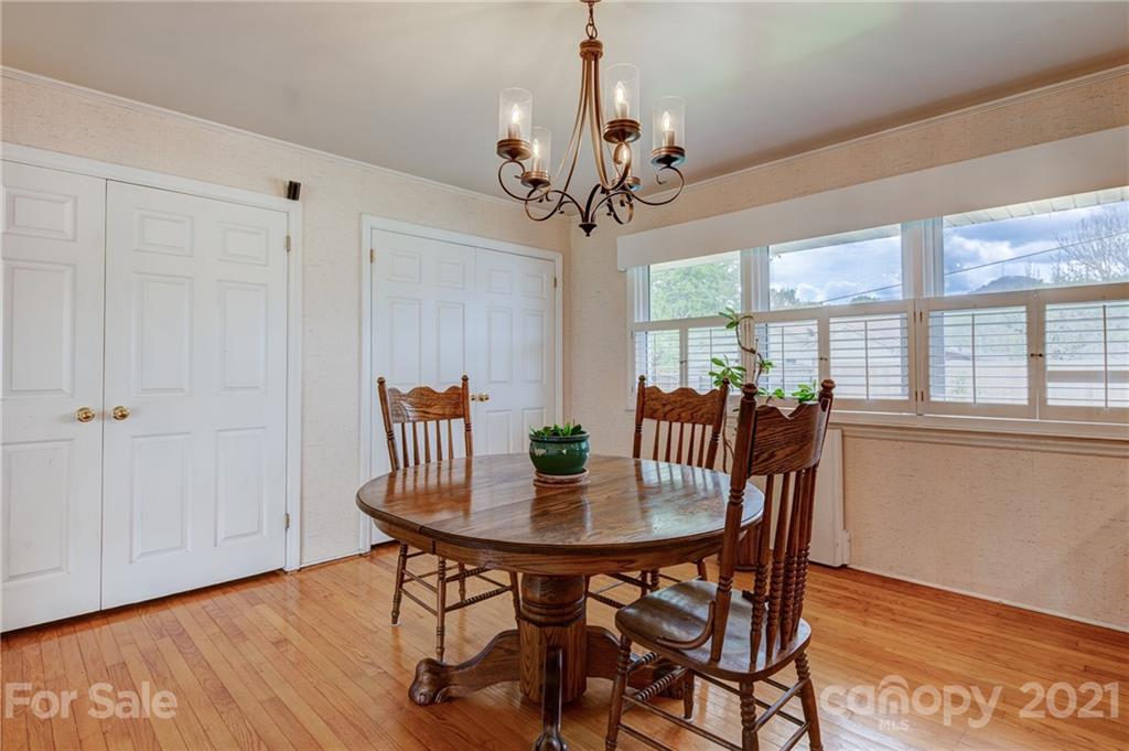 208 Wells Road Canton, NC 28716 - Photo 21 of 35 a view of a dining room with furniture window and wooden floor