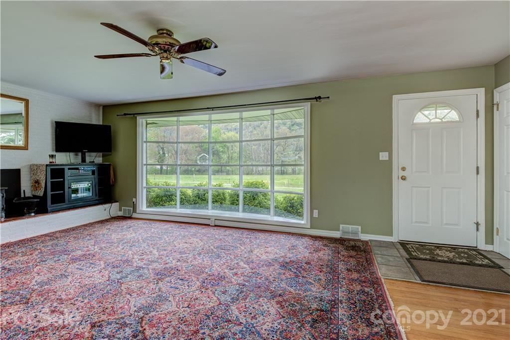 208 Wells Road Canton, NC 28716 - Photo 22 of 35 a view of an empty room with a window and a kitchen