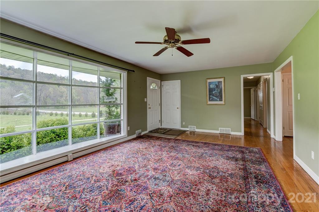 208 Wells Road Canton, NC 28716 - Photo 24 of 35 a view of empty room with wooden floor and fan