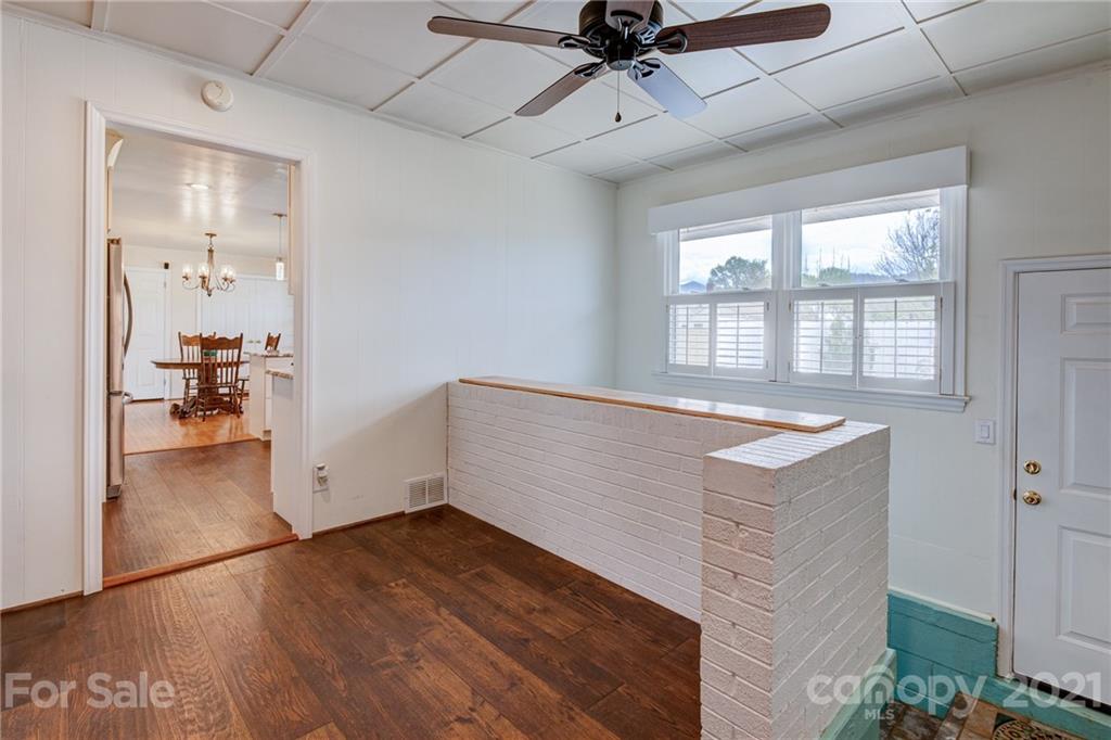 208 Wells Road Canton, NC 28716 - Photo 26 of 35 a view of empty room with wooden floor and fan
