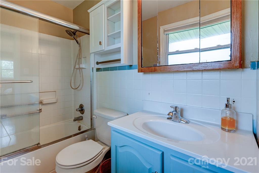 208 Wells Road Canton, NC 28716 - Photo 29 of 35 a bathroom with a sink a toilet and shower