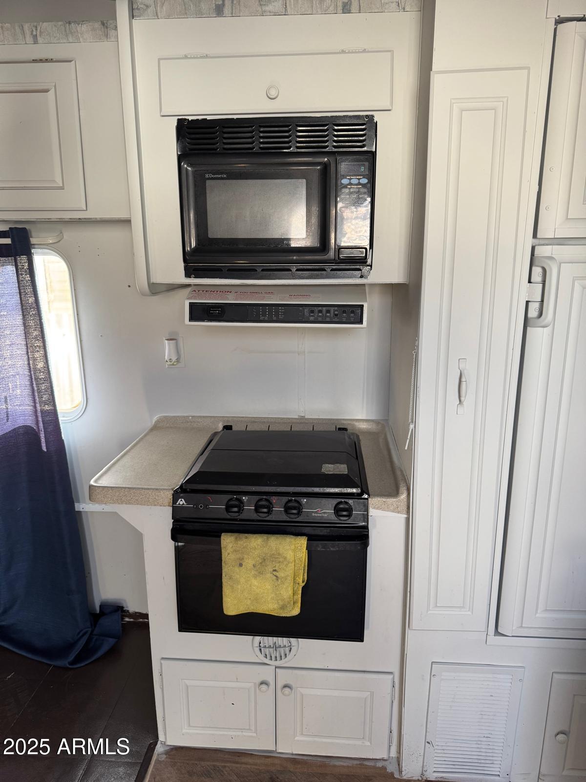 3318 West Madison Street, Unit C Phoenix, AZ 85009 - Photo 4 of 6 a stove top oven sitting inside of a kitchen