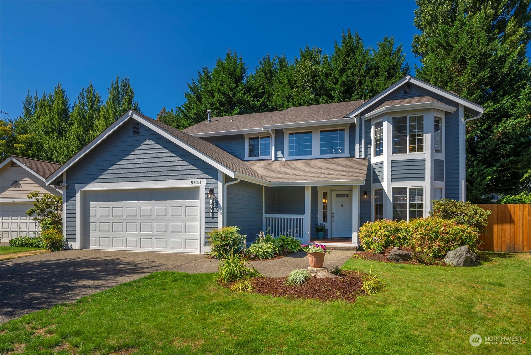 5451 Park Pl Loop Southeast Lacey, WA 98503 - Photo 2 of 36 a front view of a house with a yard and garage