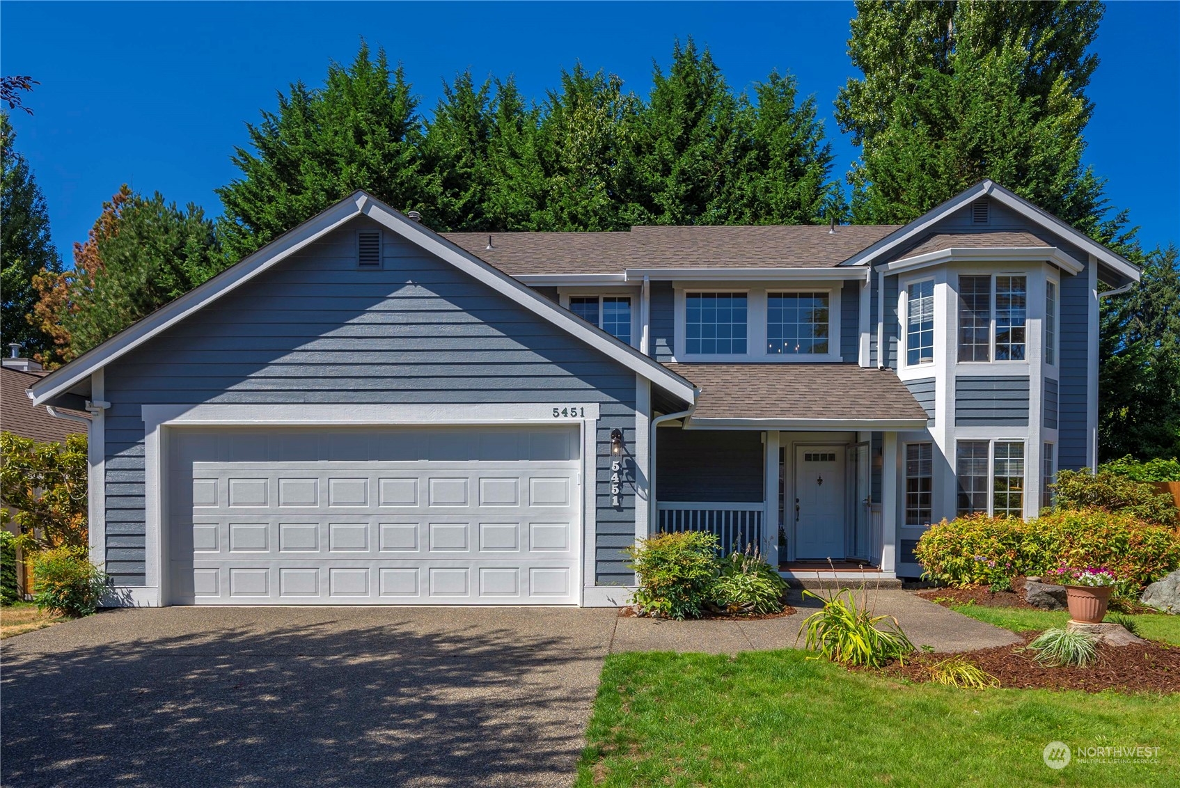 5451 Park Pl Loop Southeast Lacey, WA 98503 - Photo 36 of 36 a front view of a house with a yard and garage
