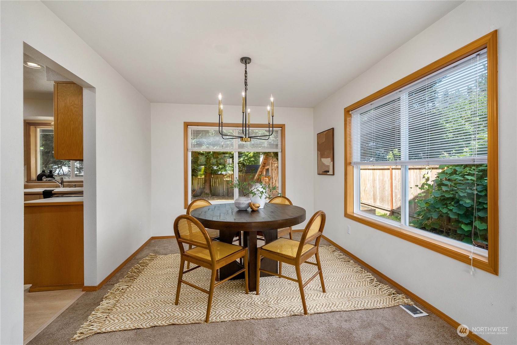 5451 Park Pl Loop Southeast Lacey, WA 98503 - Photo 8 of 36 a dining room with furniture a chandelier and wooden floor