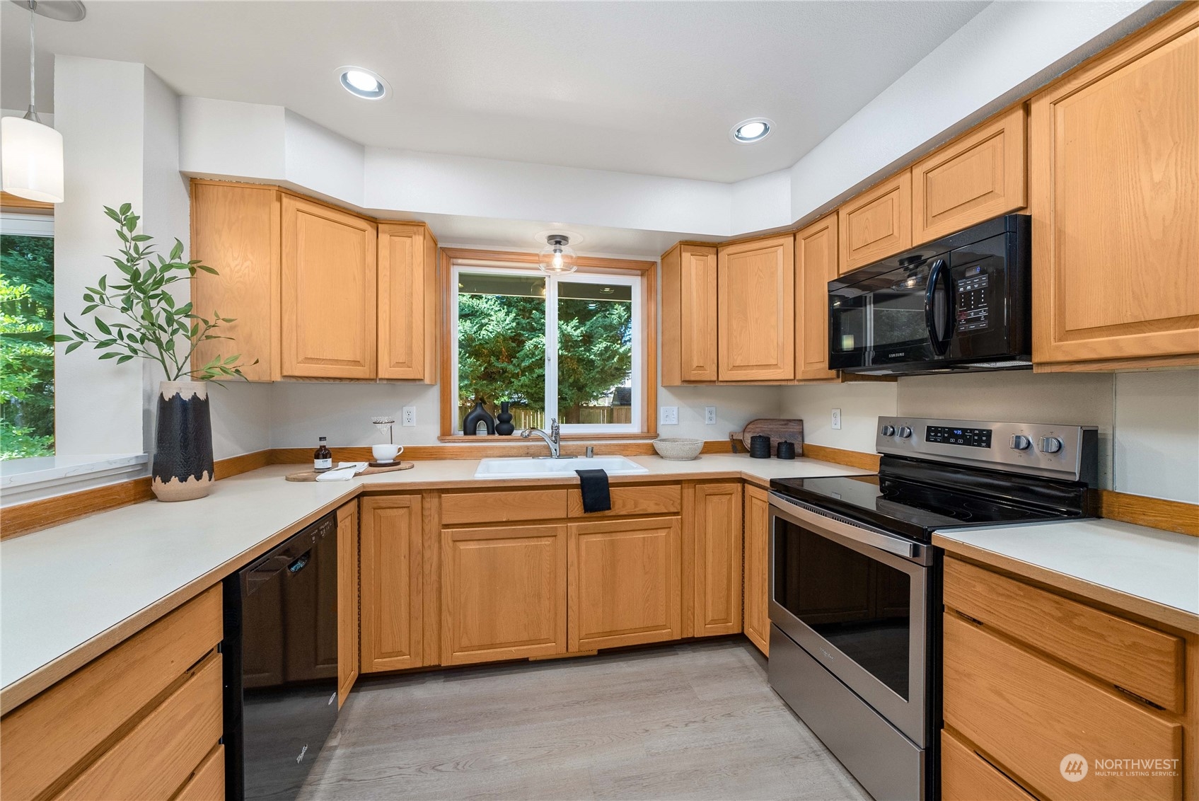 5451 Park Pl Loop Southeast Lacey, WA 98503 - Photo 9 of 36 a kitchen with a sink stove top oven and cabinets