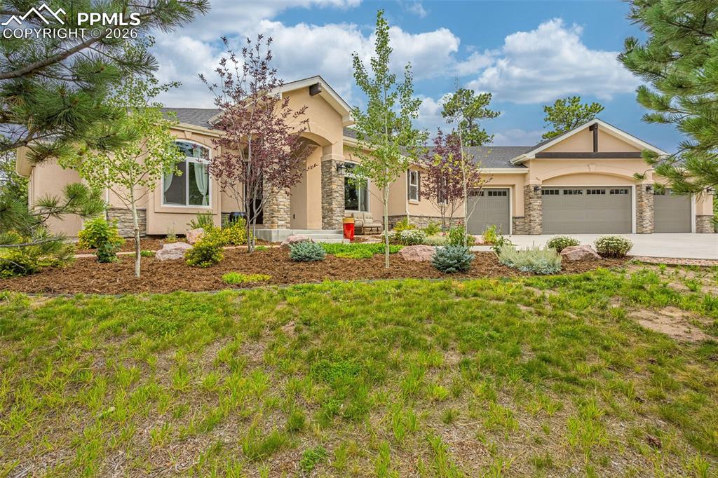 a front view of a house with a garden