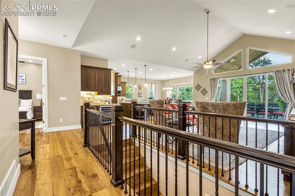1325 Boldmere Court Monument, CO 80132 - Photo 30 of 49 a view of a kitchen with kitchen island stainless steel appliances wooden floor dining table and a large window