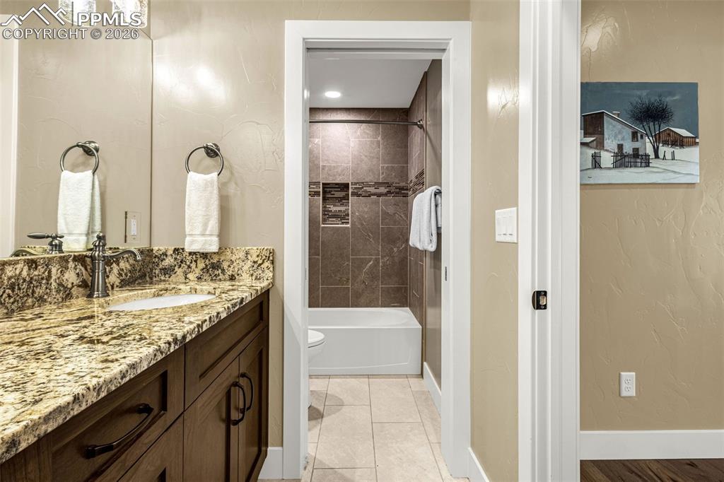 1325 Boldmere Court Monument, CO 80132 - Photo 39 of 49 a bathroom with a granite countertop sink and a mirror