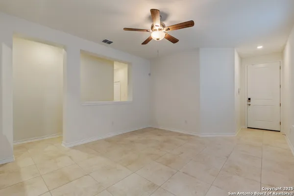 an empty room with closet and a ceiling fan