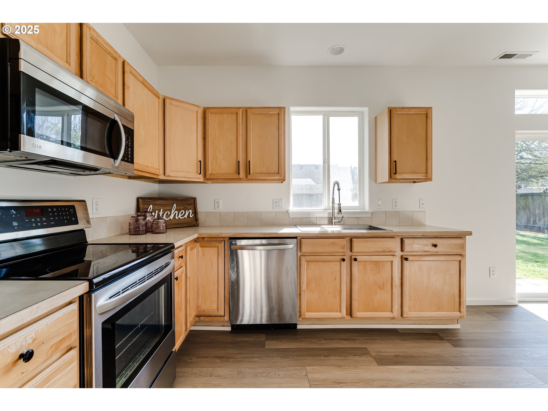 1255 Brower Avenue Eugene, OR 97402 - Photo 11 of 39 a kitchen with stainless steel appliances granite countertop a stove a sink and a microwave
