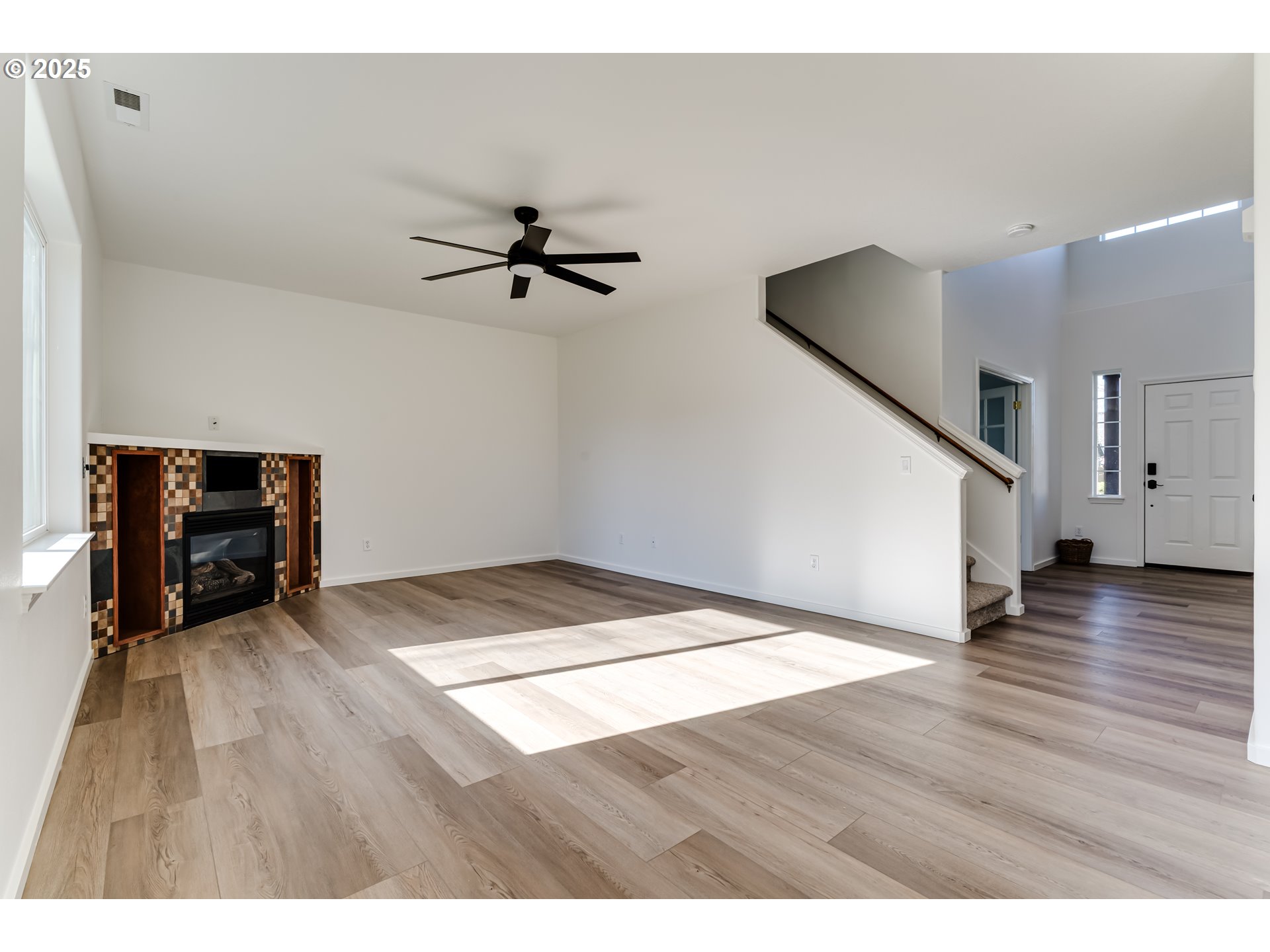 1255 Brower Avenue Eugene, OR 97402 - Photo 8 of 39 a view of an empty room with wooden floor and a ceiling fan
