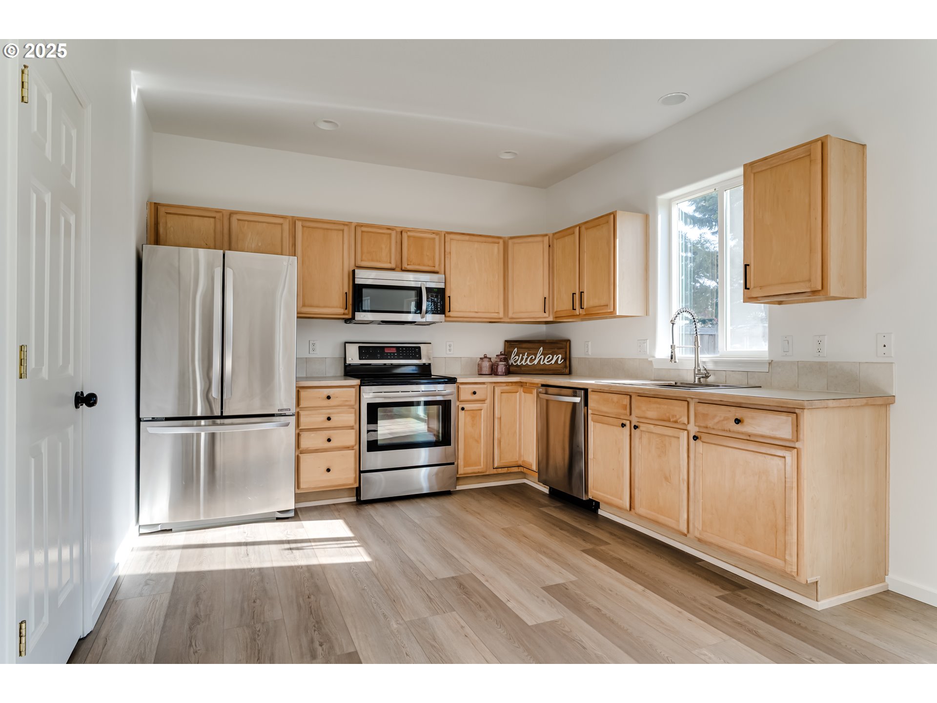 1255 Brower Avenue Eugene, OR 97402 - Photo 10 of 39 a kitchen with stainless steel appliances a refrigerator sink and microwave