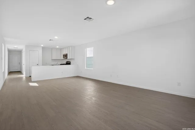 a view of a kitchen with a sink and a stove top oven
