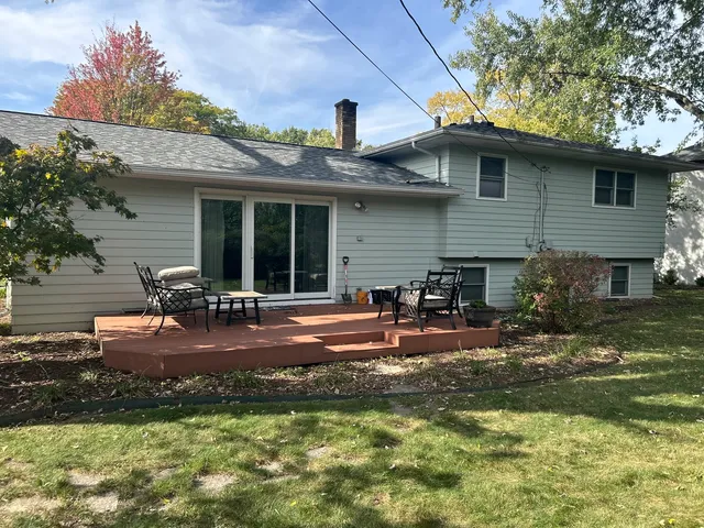 a view of a house with backyard porch and sitting area