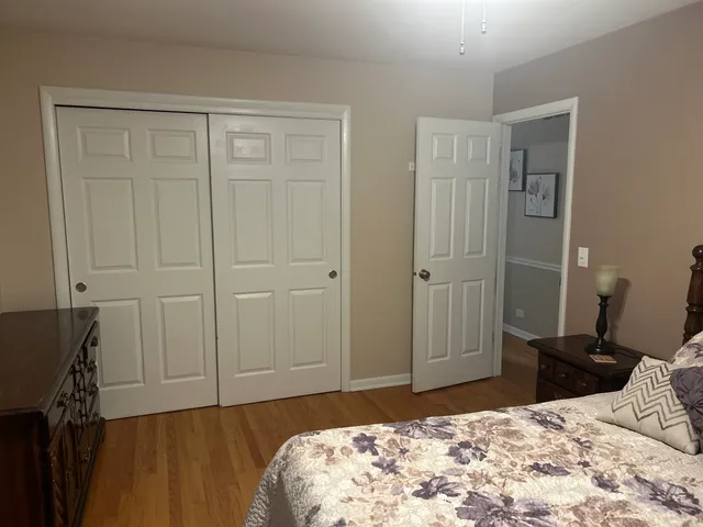 a bedroom with a bed and a dresser