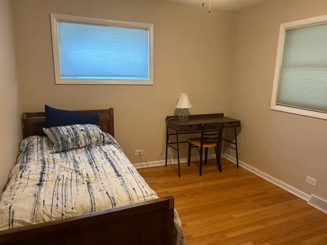 a bed sitting in a bedroom next to a window