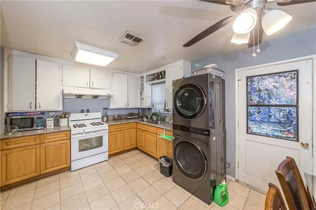 a kitchen with stove top oven and cabinets