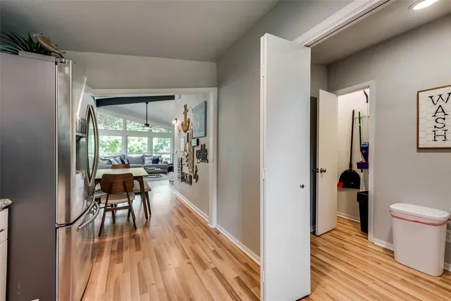 a view of a hallway view with wooden floor and a floor to ceiling window