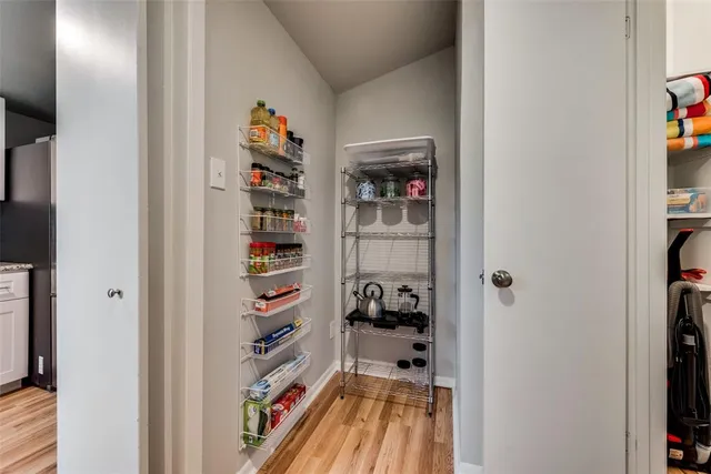 a room with a book shelf and a painting on the wall