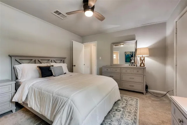 a bedroom with bed and cabinets