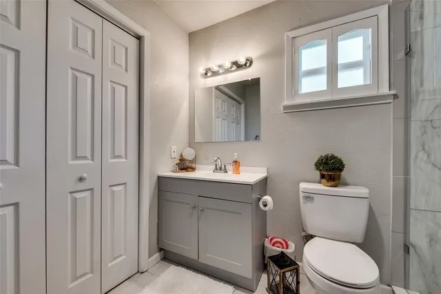a bathroom with a toilet a sink and mirror