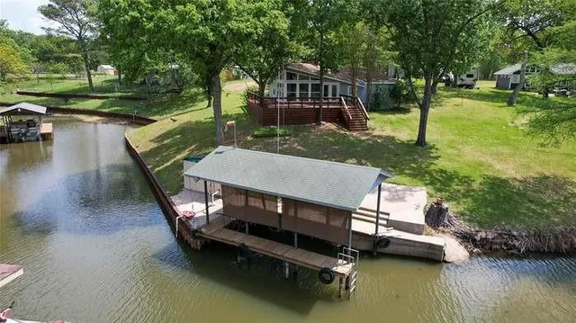 a view of a wooden deck with lake view and a floor to ceiling window