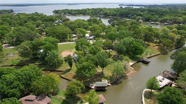 an aerial view of a house with a yard lake lake view and mountain view