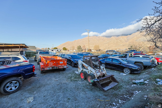 7609 Mountain View Road Lake Point, UT 84074 - Photo 16 of 16 View of vehicle parking featuring a mountain view
