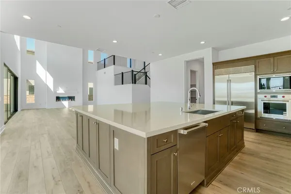 a kitchen with stainless steel appliances a sink and a wooden floors