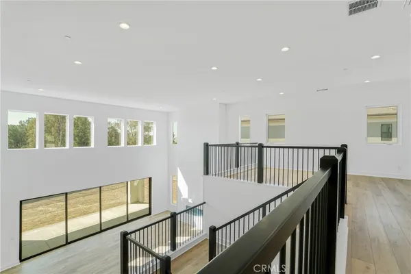 a view of staircase with wooden floor and windows