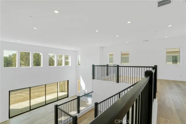 a view of staircase with wooden floor and windows