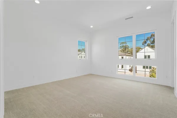 a bathroom with a granite countertop sink a toilet and a mirror