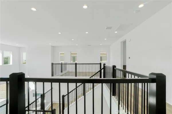 a view of staircase with railing and wooden floor
