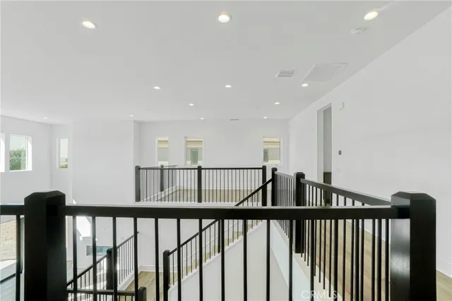 a view of staircase with railing and wooden floor