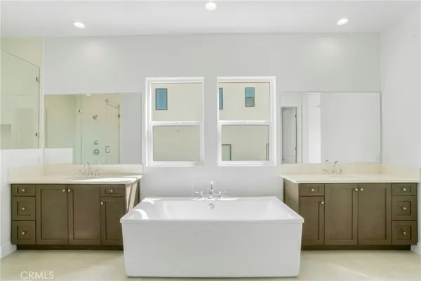a spacious bathroom with a granite countertop sink mirror and shower