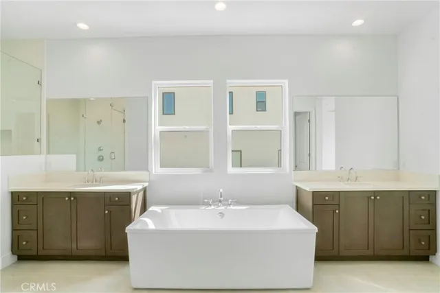 a spacious bathroom with a granite countertop sink mirror and shower