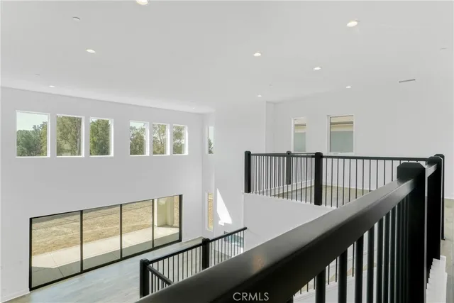 a large kitchen with stainless steel appliances granite countertop a large counter top a sink and a stove